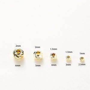 Detail of five 14K gold plated spiral spacer beads in sizes 2.5mm to 6mm for DIY jewelry