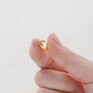 Macro shot of a 14k gold-plated lobster clasp for DIY necklace and bracelet jewelry making