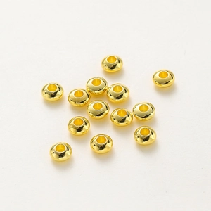 Macro detail of 18K gold plated rondelle spacer beads for DIY jewelry making