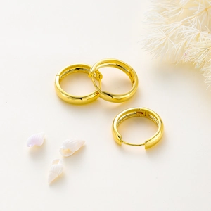 Macro shot of 14K gold plated hoop earrings with mirror polish and snap closure
