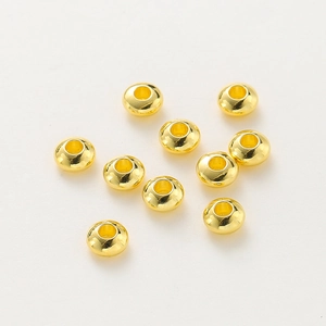 Macro shot of ten 18K gold-plated spacer beads with polished finish for DIY jewelry