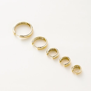 Five sizes of polished 14K gold plated hoop earrings displayed on white background