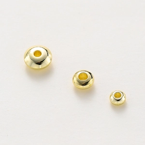 Macro shot of 18K gold-plated spacer beads with a high-polished mirror finish