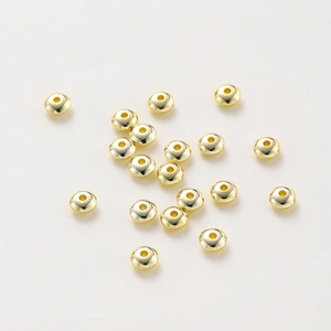 Detailed view of polished 18K gold-plated flat spacer beads for DIY jewelry making
