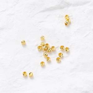 Detailed view of faceted 14K gold-plated spacer beads for DIY jewelry making