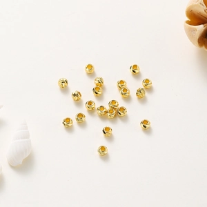 Macro view of 14K gold plated faceted pumpkin beads for DIY jewelry making