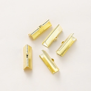 Detail of five 18K gold-plated ribbon crimp ends with teeth for DIY jewelry making