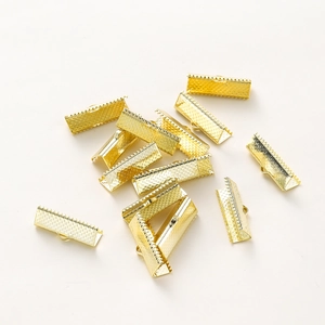 Macro detail of 18k gold plated ribbon crimp ends for jewelry making with teeth