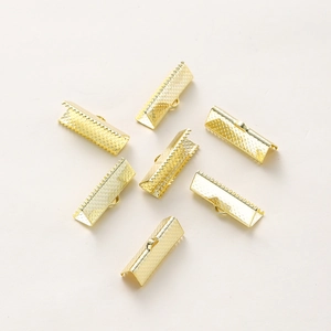 Close-up of gold-plated crimp ends with textured surface for DIY jewelry making