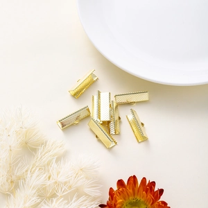 Detailed view of gold plated ribbon crimp ends with teeth and loops for DIY jewelry making