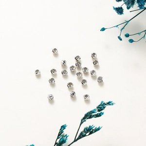 Macro shot of 14K gold plated pumpkin spacer beads with spiral cut floral pattern