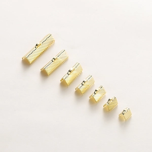 Macro shot of 7 sizes of gold plated ribbon ends with diamond pattern for DIY jewelry
