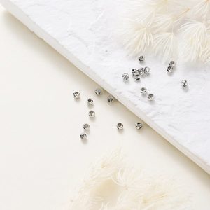 Close-up of faceted silver metal spacer beads with diamond-cut surface for DIY jewelry making
