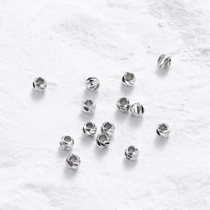 Detail of diamond-cut silver metal beads with faceted texture for DIY jewelry making