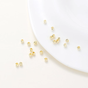 Detailed macro view of 14K gold plated faceted spacer beads for DIY jewelry making