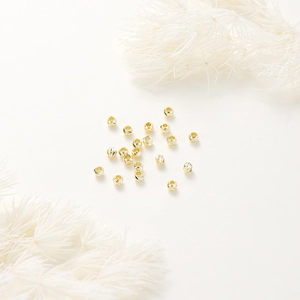 Macro shot of 14K gold-plated engraved spacer beads for DIY jewelry making
