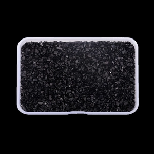 Macro shot of 3-8mm black irregular glass shards in a clear rectangle storage box