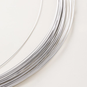 Macro shot of silver plated copper wire for jewelry making on a minimalist roll