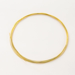 Macro detail of high-luster 14K gold plated wire roll for DIY jewelry making and crafts