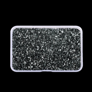 Detailed top view of irregular shiny black glass stone fragments for DIY crafts