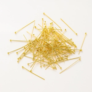 Close-up of bulk 14K gold plated copper ball head pins for DIY jewelry making supplies