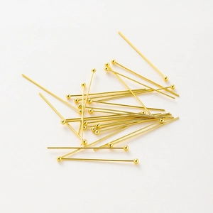 Detailed view of polished 14K gold plated ball head pins for jewelry making accessories