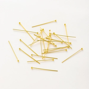 Macro shot of gold-plated ball head pins for professional DIY jewelry bead making