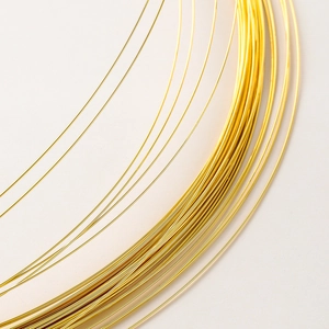 Detailed macro view of flexible 14K/18K gold-plated jewelry wire for DIY beadwork