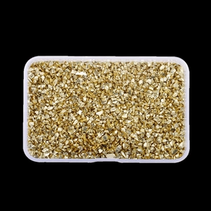 Detailed view of high-shine gold metallic crushed stones in a transparent storage box