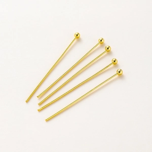 Detailed view of five 14K gold plated brass ball head pins for DIY jewelry making