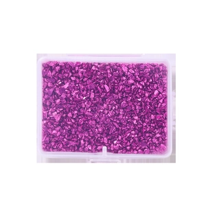 Macro view of purple metallic irregular crushed stones in a clear plastic box