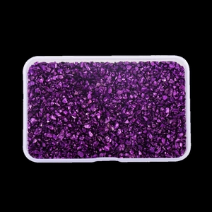 Close-up of purple metallic irregular glass shards in a clear organizer box for nail art