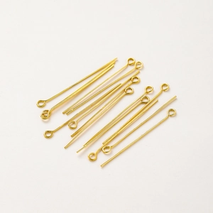 Macro shot of 18K gold-plated brass eye pins for DIY jewelry making and beading projects