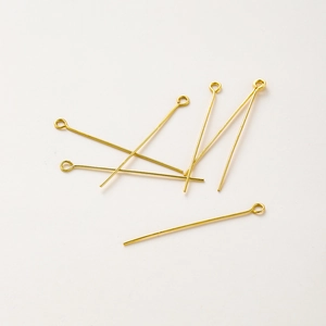Close-up of 18K gold-plated eye pins for DIY jewelry making with smooth finish