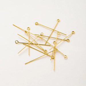 Macro shot of 18K gold-plated eye pins for DIY handmade jewelry beadwork making