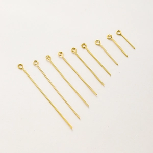 Detailed view of nine gold-plated eye pins in various sizes for DIY jewelry making