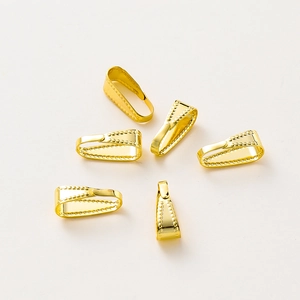 Macro-opname van 14K vergulde hanger-oogjes met kraaltextuur voor DIY-sieraden maken