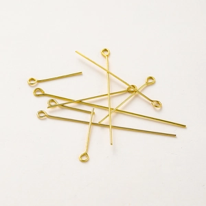 Macro shot of gold-plated brass eye pins for DIY jewelry making and beadwork