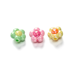 Macro detail of pearl luster acrylic flower beads in pastel green pink and yellow