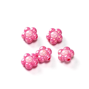 Macro detail of high-shine iridescent pink acrylic flower beads for DIY jewelry making