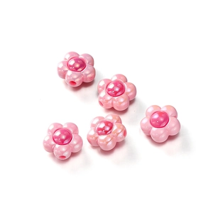 Close-up of pink pearlescent acrylic flower beads with red centers for jewelry DIY