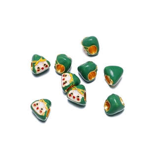 Detailed close-up of cute green enamel rice dumpling charms for DIY jewelry making