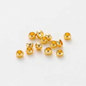 Macro shot of 14K gold-plated spacer beads with polished finish for DIY jewelry