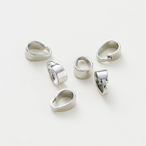 Macro shot of 6 polished white gold-plated pendant bails for DIY jewelry making