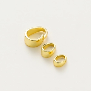 Detailed view of three sizes of high-polished 14K gold plated pendant pinch bails
