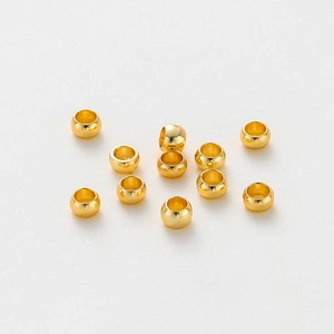 Macro detail of 14K gold plated smooth spacer beads for DIY jewelry making and crafts