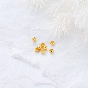 Macro detail of 14K gold plated brass spacer beads for DIY jewelry making