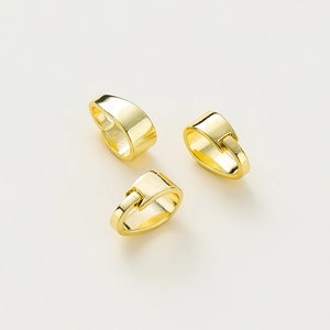 Close-up of three polished 14K gold plated pinch bails for DIY jewelry making
