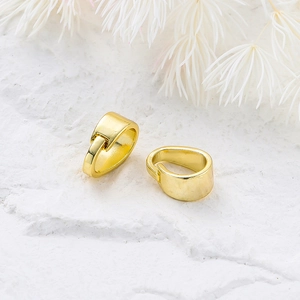 Macro shot of 14K gold-plated pinch bails for DIY jewelry making on white stone