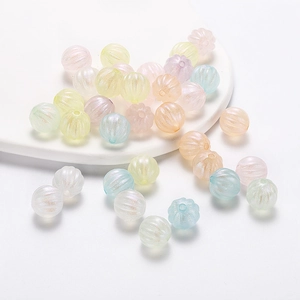 Macro shot of colorful acrylic pumpkin beads for DIY jewelry with pearlescent finish